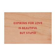 Jenny Holzer Expiring for love wooden postcard. Available at Tate Shop